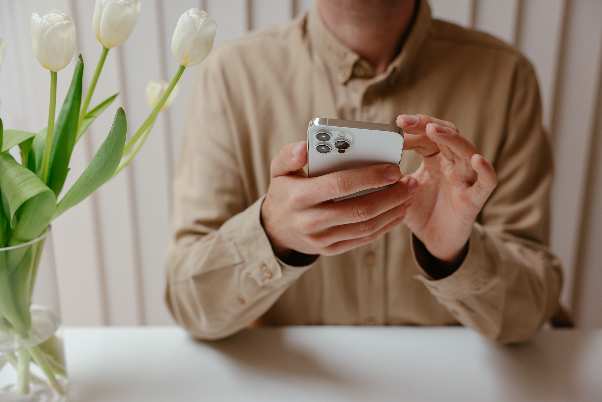 photo of a person using a smartphone with both hands